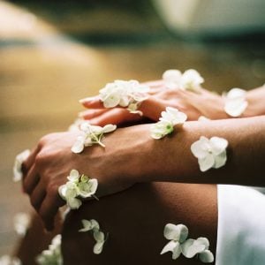 person surrounded by white flowers